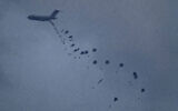 An aircraft airdrops humanitarian aid over Gaza the northern Gaza Strip, as seen from southern Israel, March 8, 2024. (AP Photo/Leo Correa)