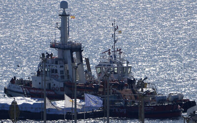 A ship, left, belonging to the Open Arms aid group departs from Larnaca, Cyprus, to Gaza with some 200 tons of rice and flour, March 12, 2024. (AP Photo/Petros Karadjias)