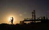A photographer prepares to makes photos of SpaceX's mega rocket Starship as it is prepared for a test flight from Starbase in Boca Chica, Texas, Wednesday, March 13, 2024. (AP/Eric Gay)