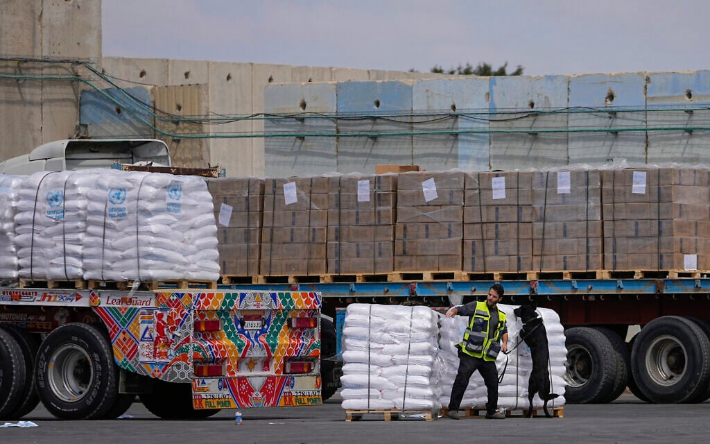 Trucks carrying humanitarian aid for the Gaza Strip pass through the inspection area at the Kerem Shalom Crossing in southern Israel, March 14, 2024. (AP/Ohad Zwigenberg)