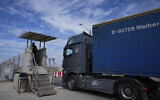 File: A truck carrying humanitarian aid for the Gaza Strip passes through the Kerem Shalom Crossing in southern Israel, Thursday, March 14, 2024. (AP/Ohad Zwigenberg)