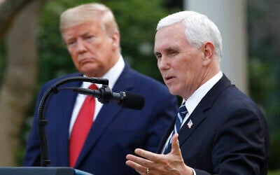 US President Donald Trump listens as Vice President Mike Pence speaks during a briefing at the White House, March 29, 2020, in Washington. (AP Photo/Patrick Semansky, File)