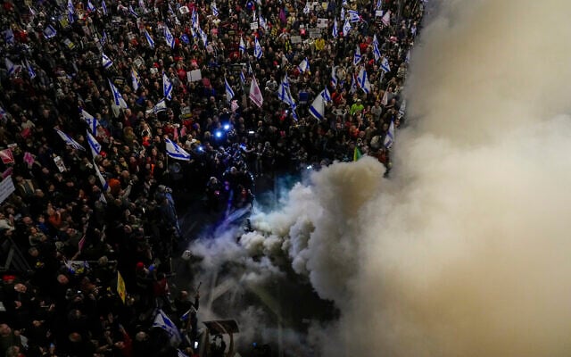 Relatives and supporters of the Israeli hostages held in the Gaza Strip by the Hamas terror group block a road during a rally calling for their release, in Tel Aviv, March 16, 2024. (AP/Ohad Zwigenberg)