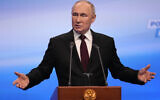 Russian President Vladimir Putin gestures while speaking on a visit to his campaign headquarters after a presidential election in Moscow, Russia, early Monday, March 18, 2024. (AP/Alexander Zemlianichenko)