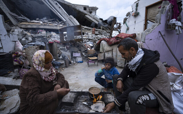 Palestinian break their fast during the Muslim holy month of Ramadan outside their destroyed home in Rafah, Gaza Strip, March 18, 2024. (AP Photo/Fatima Shbair) Palestinian break their fast during the Muslim holy month of Ramadan outside their destroyed home in Rafah, Gaza Strip, March 18, 2024. (AP Photo/Fatima Shbair)