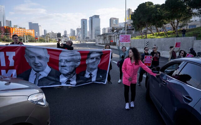 Activists block a highway as they demand the release of the hostages from Hamas captivity in the Gaza Strip, in Tel Aviv, Israel, Wednesday, March 20, 2024. (AP Photo/Oded Balilty)