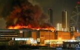 A massive blaze is seen over the Crocus City Hall on the western edge of Moscow, Russia, March 22, 2024. (Sergei Vedyashkin/Moscow News Agency via AP)