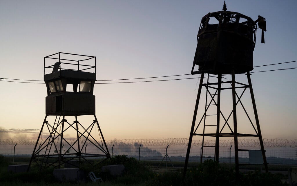 An old observation towers stand near a fence as smoke rises after an explosion in the Gaza Strip, seen from Kibbutz Nahal Oz, Feb. 28, 2024. (AP Photo/Leo Correa) An old observation towers stand near a fence as smoke rises after an explosion in the Gaza Strip, seen from Kibbutz Nahal Oz, Feb. 28, 2024. (AP Photo/Leo Correa)
