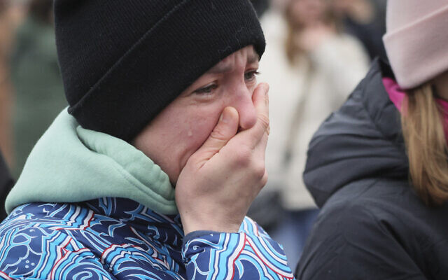 A woman reacts as she comes to place flowers at the fence next to the Crocus City Hall, on the western edge of Moscow, Russia, March 24, 2024. (Vitaly Smolnikov/AP) A woman reacts as she comes to place flowers at the fence next to the Crocus City Hall, on the western edge of Moscow, Russia, March 24, 2024. (Vitaly Smolnikov/AP)
