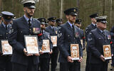 British soldiers pay tribute to Allied prisoners of war who tunneled out of a German POW camp during World War II on the 80th anniversary of the escape, in Zagan, Poland, Sunday March 24, 2024. (AP Photo/Jan Mazur)