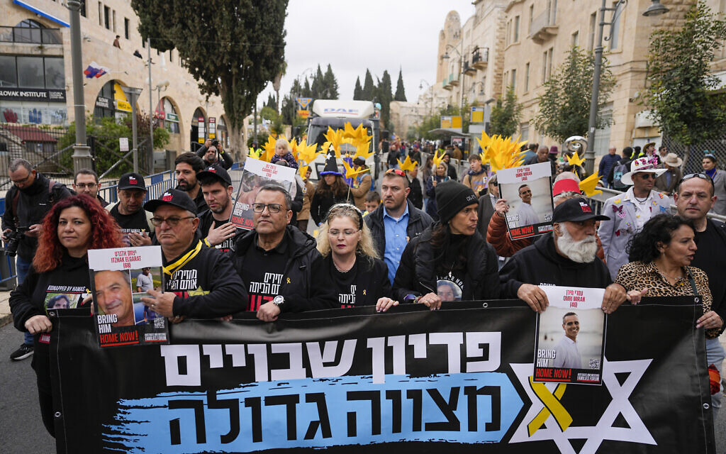 Relatives and supporters of Israeli hostages held in the Gaza Strip by the Hamas terror group lead a Purim parade in Jerusalem, March 25, 2024. (AP Photo/Ohad Zwigenberg) Relatives and supporters of Israeli hostages held in the Gaza Strip by the Hamas terror group lead a Purim parade in Jerusalem, March 25, 2024. (AP Photo/Ohad Zwigenberg)