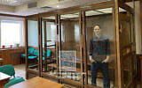 In this photo released by the Moscow City Court Press Service, Wall Street Journal reporter Evan Gershkovich stands in a glass cage in a courtroom at the Moscow City Court in Moscow, Russia, March 26, 2024. (Moscow City Court Press Service via AP)