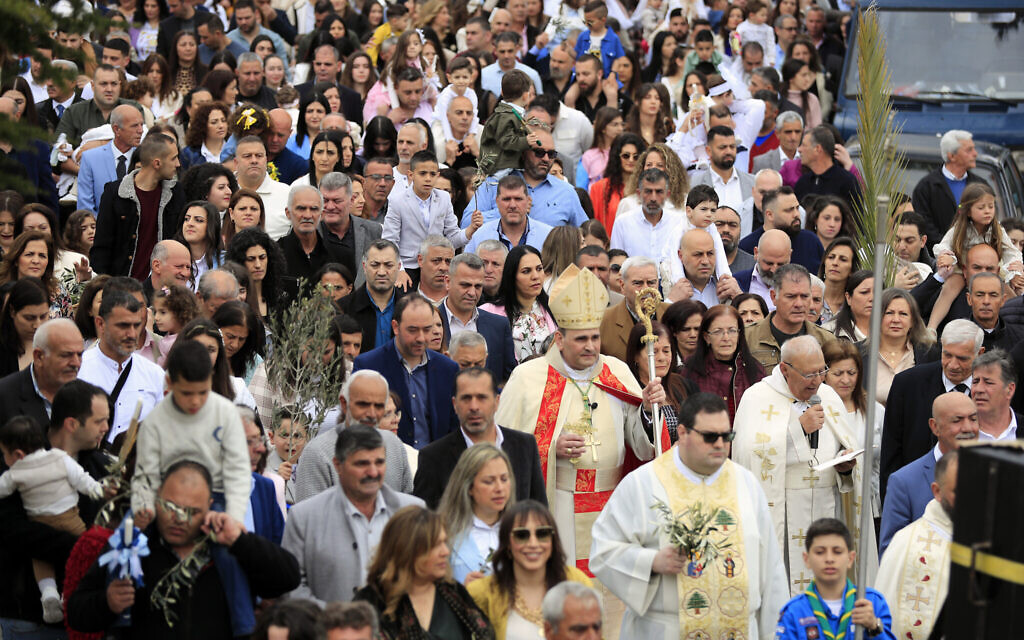 Lebanese Christians hold the olive branch and palm fronds during the traditional Palm Sunday procession in the southern village of Rmeish, a Lebanese border village with Israel, Sunday, March 24, 2024. (AP Photo/Mohammed Zaatari)