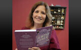 Dr. Aliza Lavie pictured with her new book, Iconic Jewish Women, during its launch in Jerusalem on March 18, 2024 (Credit: Lior Sade).