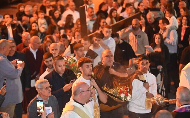 Maronite Christians attend a Good Friday procession in Haifa on March 29, 2024. (Canaan Lidor/Times of Israel)