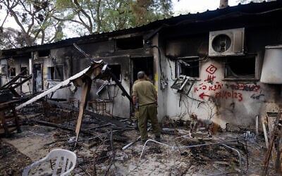 Illustrative: Israeli soldiers walking next to the destruction caused by Hamas terrorists in Kibbutz Nir Oz on October 7, 2023, near the Israeli-Gaza border, in southern Israel, November 21, 2023. (Chaim Goldberg/Flash90) Illustrative: Israeli soldiers walking next to the destruction caused by Hamas terrorists in Kibbutz Nir Oz on October 7, 2023, near the Israeli-Gaza border, in southern Israel, November 21, 2023. (Chaim Goldberg/Flash90)