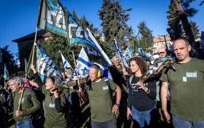 Members of the Brothers in Arms movement protest outside the house of Housing Minister Yitzchak Goldknopf in Jerusalem on February 26, 2024 (Chaim Goldberg/Flash90)