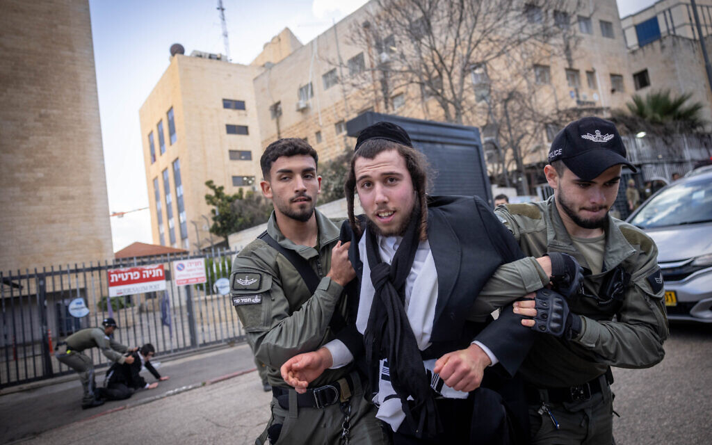 Illustrative: A Haredi man clashes with police during a protest outside an army recruitment office in Jerusalem, March 4, 2024. (Chaim Goldberg/Flash90) Illustrative: A Haredi man clashes with police during a protest outside an army recruitment office in Jerusalem, March 4, 2024. (Chaim Goldberg/Flash90)