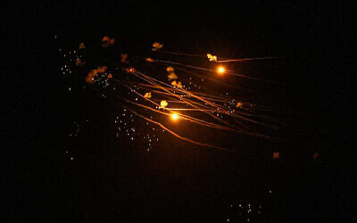 A barrage of rockets launched by Hezbollah in Lebanon is intercepted by the Iron Dome over Kiryat Shmona, March 5, 2024. (Ayal Margolin/Flash90)