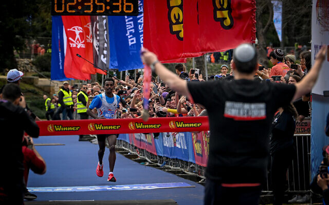 Melkamu Jember reaches the finish line first during the annual Jerusalem Marathon on March 8, 2024. (Arie Leib Abrams/Flash90)