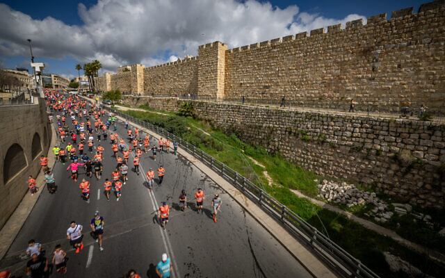 Thousands of runners take part in the annual Jerusalem marathon near the Old City of Jerusalem, on March 8, 2024. (Yonatan Sindel/Flash90)
