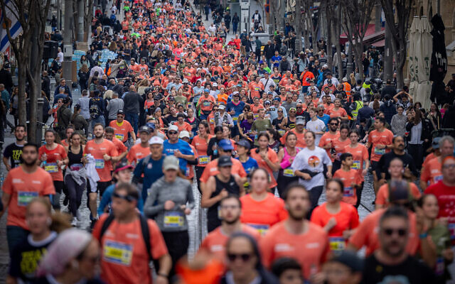 Thousands of runners take part in the annual Jerusalem marathon, on Jaffa Street in Jeruslem, on March 8, 2024. (Yonatan Sindel/Flash90)