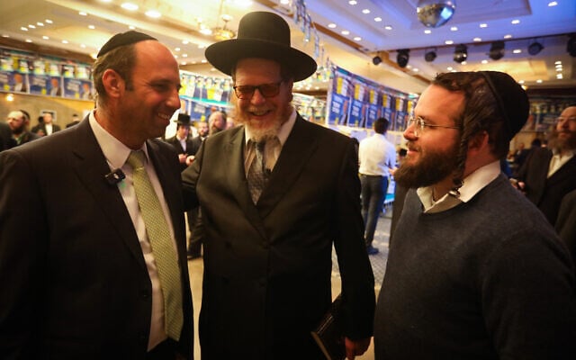 Shmuel Greenberg, left, speaks to supporters at his election headquarters during the second round of Municipal Elections, in Beit Shemesh, March 10, 2024. (Yaakov Lederman/Flash90) Shmuel Greenberg, left, speaks to supporters at his election headquarters during the second round of Municipal Elections, in Beit Shemesh, March 10, 2024. (Yaakov Lederman/Flash90)