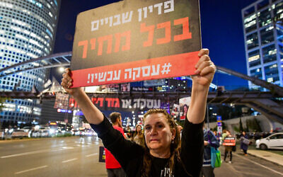 An activist  in Tel Aviv calls for the government to agree to a deal releasing hostages held in Gaza, on March 12, 2024. (Avshalom Sassoni/Flash90)