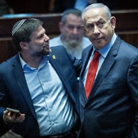 Prime Minister Benjamin Netanyahu (right) and Finance Minister Bezalel Smotrich attend a vote at the Knesset in Jerusalem, March 13, 2024. (Yonatan Sindel/Flash90)