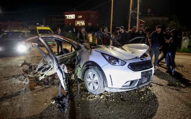 Palestinians stand near a car that was hit by an Israeli airstrike, in the West Bank city of Jenin, March 20, 2024. (Nasser Ishtayeh/Flash90) Palestinians stand near a car that was hit by an Israeli airstrike, in the West Bank city of Jenin, March 20, 2024. (Nasser Ishtayeh/Flash90)