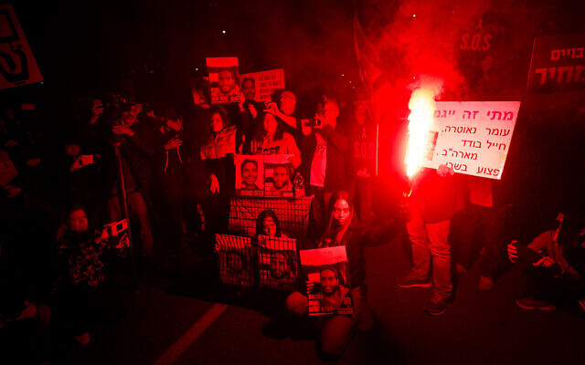 Demonstrators protest for the release of Israeli hostages held in the Gaza Strip outside the Kirya military headquarters in Tel Aviv, March 26, 2024. (Chaim Goldberg/Flash90)