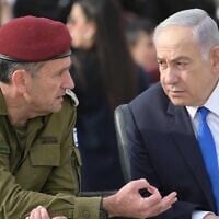 IDF Chief of Staff Lt. Gen. Herzi Halevi (left) and Prime Minister Benjamin Netanyahu attend a cadets graduation ceremony at the IDF's officers school in southern Israel, known as Bahad 1, March 7, 2024. (Amos Ben Gershom/GPO)