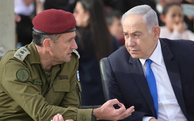 IDF Chief of Staff Lt. Gen. Herzi Halevi (left) and Prime Minister Benjamin Netanyahu attend a cadets graduation ceremony at the IDF's officers school in southern Israel, known as Bahad 1, March 7, 2024. (Amos Ben Gershom/GPO)