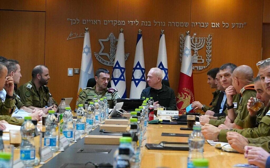 Defense Minister Yoav Gallant, right, with IDF Chief Herzi Halevi at a meeting with top army brass on March 11, 2024. (Ariel Hermoni / Defense Ministry)