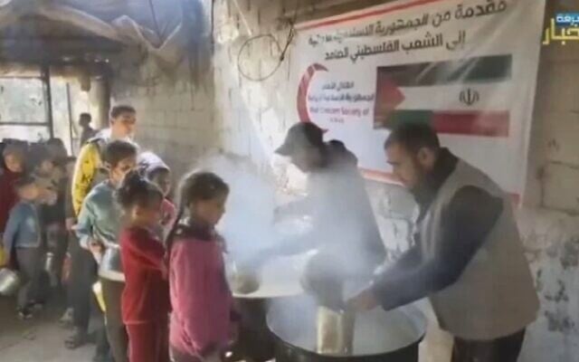 Volunteers distribute food to Palestinian children in an Iran-funded shelter in southern Gaza in footage that aired on the Kan public broadcaster on March 7, 2024. (Screen capture/X) Volunteers distribute food to Palestinian children in an Iran-funded shelter in southern Gaza in footage that aired on the Kan public broadcaster on March 7, 2024. (Screen capture/X)