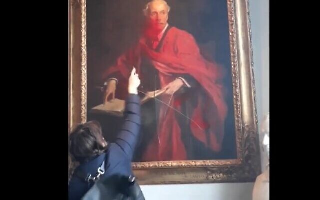 A pro-Palestinian radical activist vandalizes a historic portrait of Lord Arthur Balfour at Cambridge University on March 8, 2024. (Screen capture/X) A pro-Palestinian radical activist vandalizes a historic portrait of Lord Arthur Balfour at Cambridge University on March 8, 2024. (Screen capture/X)