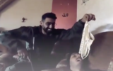 An IDF soldier playing with lingerie in Gaza. (X screenshot)