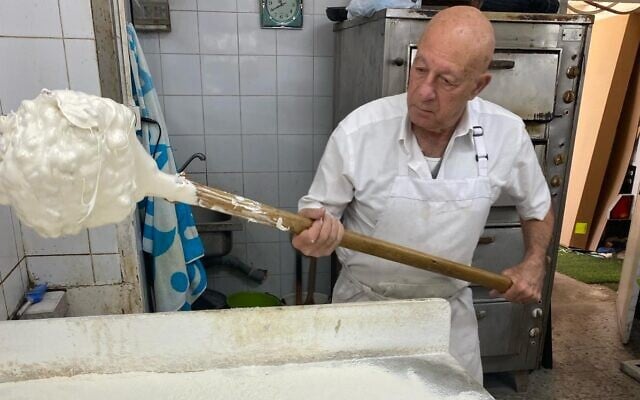 Owner and proprietor Tzvi David makes baba qadrasi at Konditorei David, March 2024. (Courtesy)