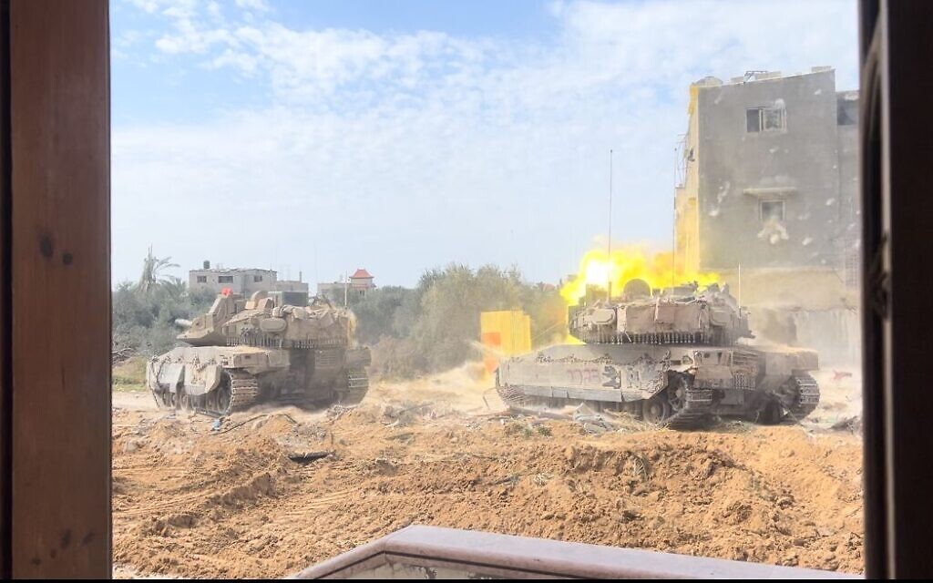 A tank belonging to the 82nd Armored Brigade opens fire north of Khan Younis, March 21, 2024 (Lazar Berman/The Times of Israel)
