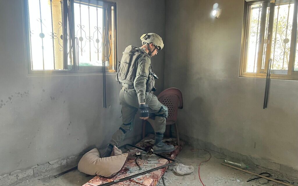 A soldier from the 603rd Combat Engineering Battalion prepares a home for demolition, March 21, 2024 (Lazar Berman/The Times of Israel)