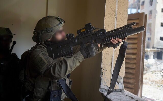 IDF troops operate in the Hamad Town residential complex in southern Gaza's Khan Younis, in a handout photo published March 13, 2024. (Israel Defense Forces)