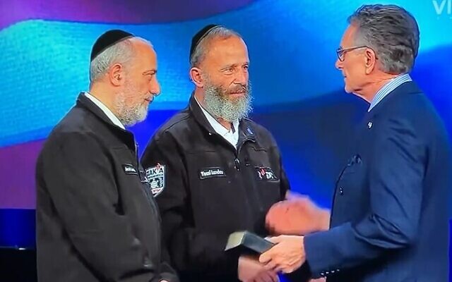 Yossi Landau, center, stands on stage with his brother Jacob and Pastor George Pearsons on February 2, 2024 in Newark, Texas. (Screenshot taken from the Facebook page of Eagle Mountain International Church) Yossi Landau, center, stands on stage with his brother Jacob and Pastor George Pearsons on February 2, 2024 in Newark, Texas. (Screenshot taken from the Facebook page of Eagle Mountain International Church)