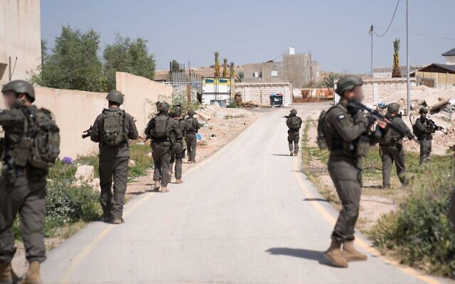 Troops search for the attacker in terror shooting in the West Bank town of al-Aujaar near Route 90, March 28, 2024. (IDF) Troops search for the attacker in terror shooting in the West Bank town of al-Aujaar near Route 90, March 28, 2024. (IDF)