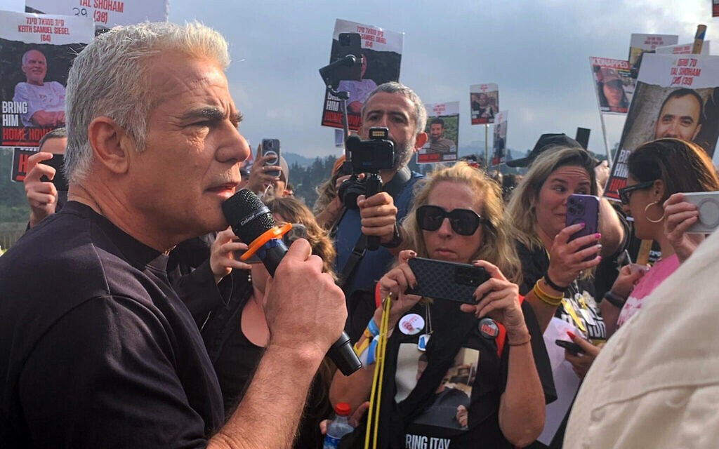 Opposition leader Yair Lapid speaks at a 'unity march' from Re'im, near Gaza, to Jerusalem, on March 2, 2024. (Charlie Summers/Times of Israel)