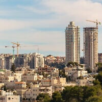 Illustrative: Tall buildings under construction in Jerusalem, June 2021. (Vladimir1965 via iStock by Getty Images)