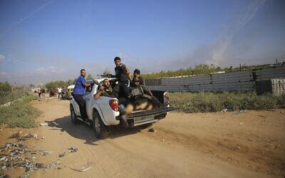 Palestinian terrorists drive to the Gaza Strip with what is believed to be the body of Shani Louk, on October 7, 2023. (AP/Ali Mahmud)