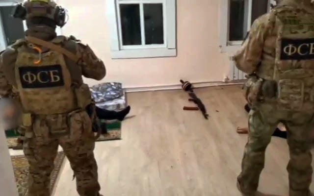 Russian FSB forces stand over Islamic State terrorists killed in a firefight, in Kaluga, Russia, March 7, 2024. (X video screenshot: used in accordance with Clause 27a of the Copyright Law)