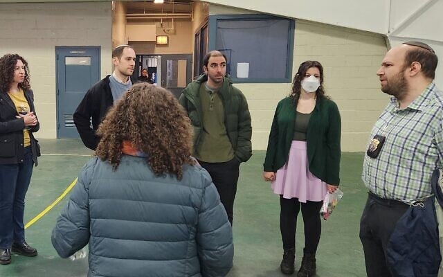 Rabbi Gabriel Kretzmer-Seed, right, speaks with volunteers about his work as the Jewish chaplain at Rikers. (NYC Department of Corrections)