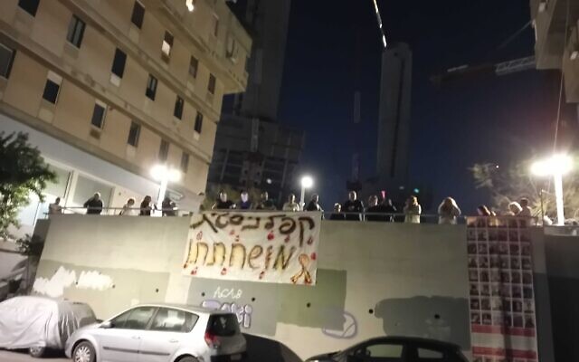 Protesters outside Attorney General Gali Baharav-Miara's Tel Aviv home unfurl a massive banner which reads 'corrupt Kaplan-goer,' referring to the Tel-Aviv street where numerous anti-government demonstrations took place, April 3, 2024. (Noam Lehmann/Times of Israel) Protesters outside Attorney General Gali Baharav-Miara's Tel Aviv home unfurl a massive banner which reads 'corrupt Kaplan-goer,' referring to the Tel-Aviv street where numerous anti-government demonstrations took place, April 3, 2024. (Noam Lehmann/Times of Israel)