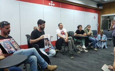 Members of Kibbutz Kfar Aza speak to reporters in their temporary home of Kibbutz Shefaim on April 3, 2024. (Maya Zanger-Nadis/Times of Israel)